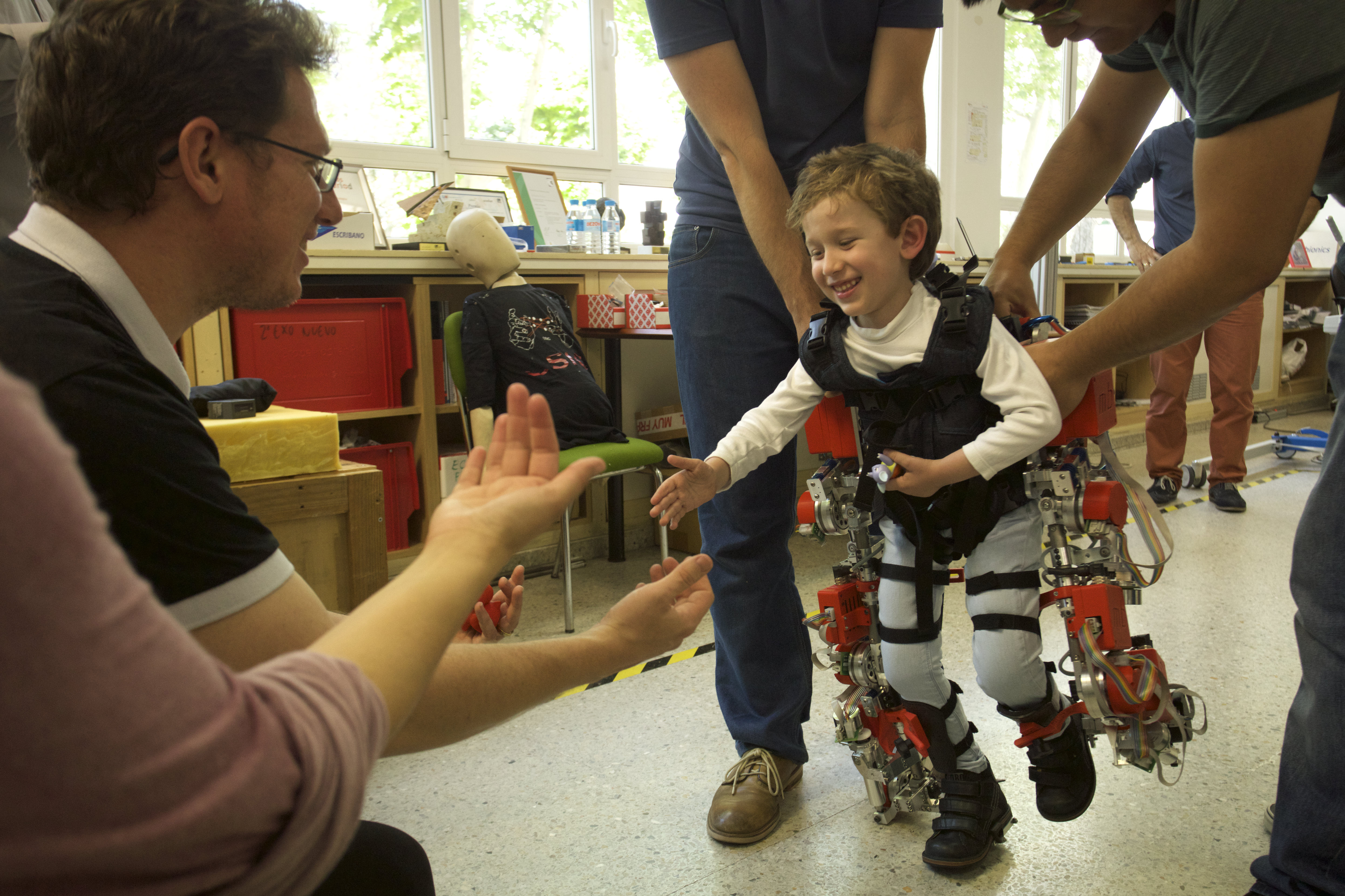 child walking for the first time with the exotrainer exoskeleton